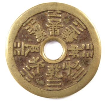 Reverse side of
      Chinese charm displaying the bagua or eight trigrams