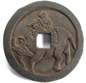 Reverse
                  side of "hong wu tong bao" charm showing a
                  boy (Emperor Tai Zu of the Ming Dynasty) riding an ox
                  (water buffalo)